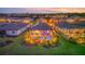 Aerial view of home with screened-in pool, lush landscaping, and sunset sky at 20828 Cattail Blvd, Venice, FL 34292
