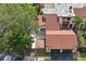 Aerial view of a townhome with a brown roof, fenced yard, and two-car garage at 2095 Sunset Point Rd # 2201, Clearwater, FL 33765