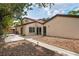 Backyard patio featuring sliding glass doors, a landscaped garden bed, and sidewalk detail at 2095 Sunset Point Rd # 2201, Clearwater, FL 33765