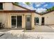 A back patio with a sliding glass door and a decorative glass front door offers outdoor living at 2095 Sunset Point Rd # 2201, Clearwater, FL 33765