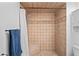 Walk-in tiled shower with built-in bench and neutral palette at 2095 Sunset Point Rd # 2201, Clearwater, FL 33765