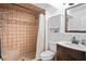 Bathroom features tiled shower with built-in bench, updated vanity, and neutral palette at 2095 Sunset Point Rd # 2201, Clearwater, FL 33765