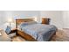 Bedroom with rustic wooden bed frame, wood-look tile flooring, and ensuite bathroom at 2095 Sunset Point Rd # 2201, Clearwater, FL 33765