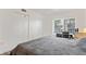 Bedroom with wood-look tile flooring, large window, and double closets at 2095 Sunset Point Rd # 2201, Clearwater, FL 33765