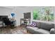 Inviting bedroom with large window, gray couch and custom workspace, bathed in natural light at 2095 Sunset Point Rd # 2201, Clearwater, FL 33765