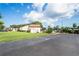 Well-maintained community area with lush green lawn, parking, and easy access for residents at 2095 Sunset Point Rd # 2201, Clearwater, FL 33765