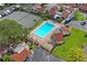 Community pool area with tennis court, lounge chairs, and well-kept landscaping at 2095 Sunset Point Rd # 2201, Clearwater, FL 33765