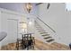 Living area features high ceilings, modern chandelier, and staircase with stone accents at 2095 Sunset Point Rd # 2201, Clearwater, FL 33765