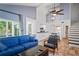 Spacious living room with high ceilings, modern lighting, and staircase access to upper level at 2095 Sunset Point Rd # 2201, Clearwater, FL 33765