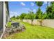 Spacious backyard featuring a lush lawn, young trees, manicured shrubs, and white vinyl fencing at 2513 Sunray Venus Way, Ruskin, FL 33570