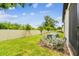 Well-maintained backyard with lush lawn, young trees, manicured shrubs, and white vinyl fencing at 2513 Sunray Venus Way, Ruskin, FL 33570