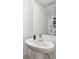 Modern bathroom featuring a pedestal sink with chrome faucet and geometric wallpaper design at 2513 Sunray Venus Way, Ruskin, FL 33570