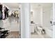 View of a walk-in closet and bright bathroom with tub, shower, and vanity at 2513 Sunray Venus Way, Ruskin, FL 33570