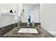 Bathroom vanity features a granite countertop, undermount sink, and open doorway at 2513 Sunray Venus Way, Ruskin, FL 33570