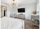 Comfortable bedroom with neutral decor and a TV mounted on the wall at 2513 Sunray Venus Way, Ruskin, FL 33570