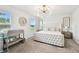 Bright bedroom featuring a tufted bed, changing table, and lots of light at 2513 Sunray Venus Way, Ruskin, FL 33570