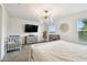 Stylish bedroom with modern lighting, neutral tones, and ample natural light at 2513 Sunray Venus Way, Ruskin, FL 33570