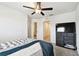 Comfortable bedroom with walk-in closet and modern TV setup, perfect for relaxation at 2513 Sunray Venus Way, Ruskin, FL 33570