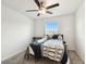 Well-lit bedroom with a ceiling fan, a cozy bed, and a window view at 2513 Sunray Venus Way, Ruskin, FL 33570