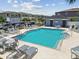 Community pool featuring sun loungers, ample seating, and convenient bath house at 2513 Sunray Venus Way, Ruskin, FL 33570