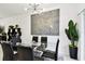 Bright dining area featuring a modern chandelier, glass table, and stylish black chairs at 2513 Sunray Venus Way, Ruskin, FL 33570
