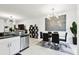 Open concept dining area featuring a modern chandelier, black dining set, and adjacent kitchen at 2513 Sunray Venus Way, Ruskin, FL 33570