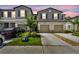 Charming townhome showcasing well-manicured lawn and a two-car garage, enhancing its curb appeal at 2513 Sunray Venus Way, Ruskin, FL 33570