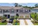 Two-story townhome featuring a two-car garage and well-maintained landscaping at 2513 Sunray Venus Way, Ruskin, FL 33570