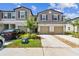 Charming townhome showcasing well-manicured lawn and a two-car garage, enhancing its curb appeal at 2513 Sunray Venus Way, Ruskin, FL 33570