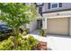 Exterior view of home featuring a front yard with green shrubbery and a one car garage at 2513 Sunray Venus Way, Ruskin, FL 33570