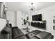 Open concept living room with modern décor featuring white tile flooring and an elegant chandelier at 2513 Sunray Venus Way, Ruskin, FL 33570