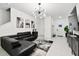 Open concept living room with modern décor featuring white tile flooring and an elegant chandelier at 2513 Sunray Venus Way, Ruskin, FL 33570