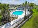 Community pool surrounded by lounge chairs and lush landscaping at 2513 Sunray Venus Way, Ruskin, FL 33570