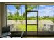 View from screened patio to manicured lawn and backyard with white vinyl fence for privacy at 2513 Sunray Venus Way, Ruskin, FL 33570