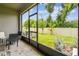View from screened patio to backyard with white vinyl fence and landscaping at 2513 Sunray Venus Way, Ruskin, FL 33570