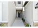 Neutral walkway leads to front door with light fixtures and easy access at 2513 Sunray Venus Way, Ruskin, FL 33570
