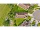 Top down aerial view of the roof, landscaping, and adjacent home at 26616 Whirlaway Ter, Wesley Chapel, FL 33544