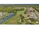 Scenic aerial view of the property backing onto a golf course and featuring beautiful lake views at 26616 Whirlaway Ter, Wesley Chapel, FL 33544