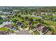 Picturesque aerial view of a golf community featuring serene ponds and well-manicured lawns at 26616 Whirlaway Ter, Wesley Chapel, FL 33544