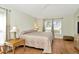 Serene bedroom with hardwood floors, a large window, and neutral decor, creating a relaxing atmosphere at 26616 Whirlaway Ter, Wesley Chapel, FL 33544