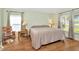 Calm bedroom with wood floors and windows that provide natural light and nice outdoor views at 26616 Whirlaway Ter, Wesley Chapel, FL 33544