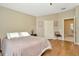 Serene bedroom showcasing neutral tones, hardwood floors, and ample closet space at 26616 Whirlaway Ter, Wesley Chapel, FL 33544