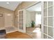 Inviting foyer with hardwood floors and glass paneled doors leading to a bright living space at 26616 Whirlaway Ter, Wesley Chapel, FL 33544