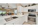 Modern kitchen with stainless steel appliances and an open floor plan view to the living room at 26616 Whirlaway Ter, Wesley Chapel, FL 33544