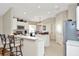 Bright kitchen with white cabinetry, stainless steel appliances, and a cozy dining area at 26616 Whirlaway Ter, Wesley Chapel, FL 33544