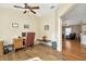Well-lit home office featuring hardwood floors and an open doorway to other living areas at 26616 Whirlaway Ter, Wesley Chapel, FL 33544