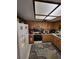 Kitchen with white appliances, wood cabinets, and accent rug at 2685 Sabal Springs Cir # 202, Clearwater, FL 33761