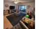 Cozy living room with sliders to the lanai and grey rug at 2685 Sabal Springs Cir # 202, Clearwater, FL 33761