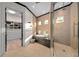 Elegant bathroom features a soaking tub, glass-enclosed shower, and access to a walk-in closet for convenience at 2711 W Trilby Ave, Tampa, FL 33611
