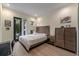 Well-lit bedroom with neutral walls, ensuite bath, private balcony, and spacious storage at 2711 W Trilby Ave, Tampa, FL 33611